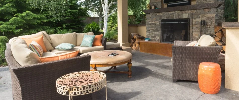 Outdoor fireplace in Lititz, PA, with table and couch.
