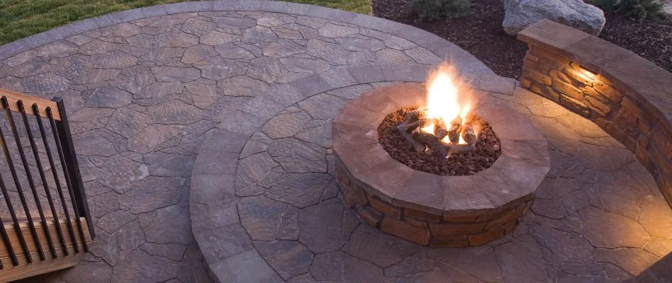 Patio in Lititz, PA, with a fire pit and a seating wall.