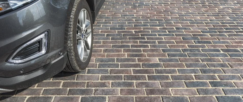 Paver driveway in Lititz, PA, with black car.