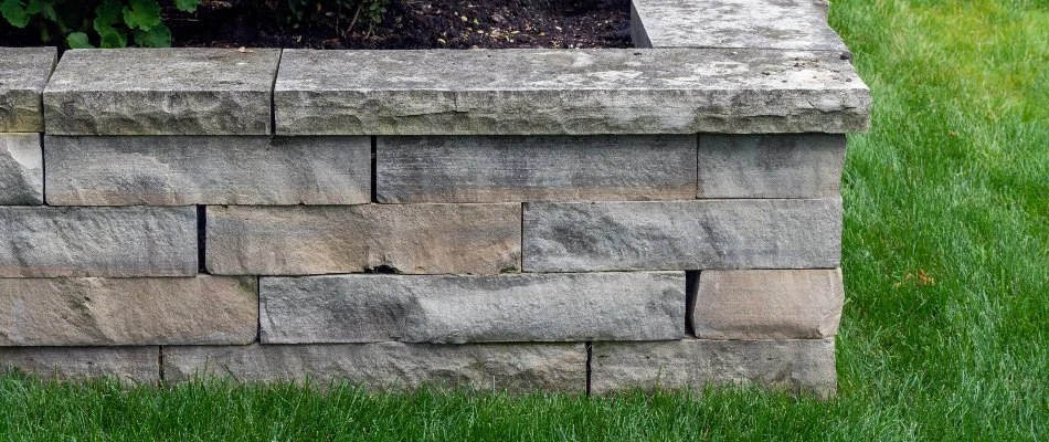 Block retaining wall in Lititz, PA, in grass.