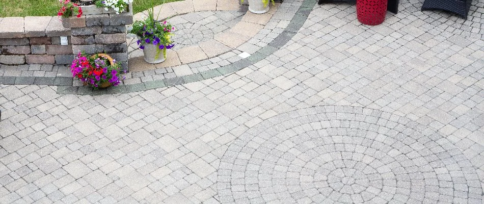 Patterned paver patio in Lititz, PA, with flowers.