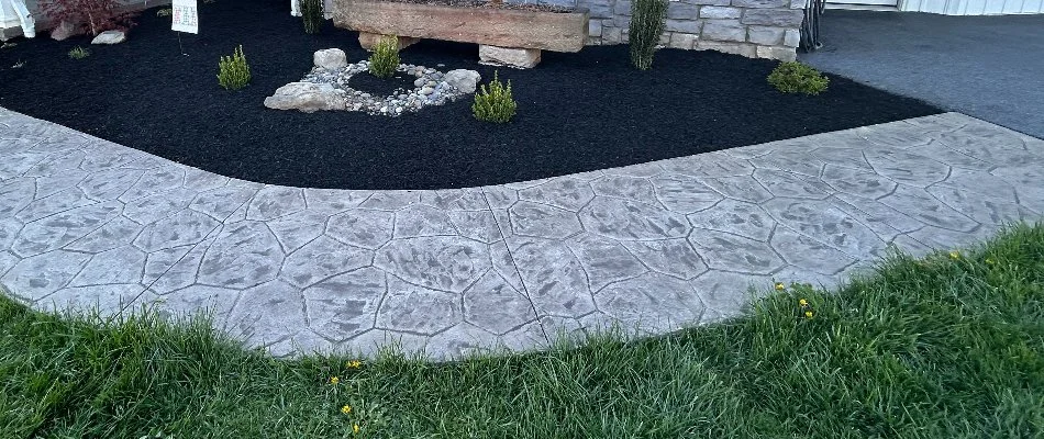 Stamped concrete walkway and a mulched landscape bed in Lititz, PA.